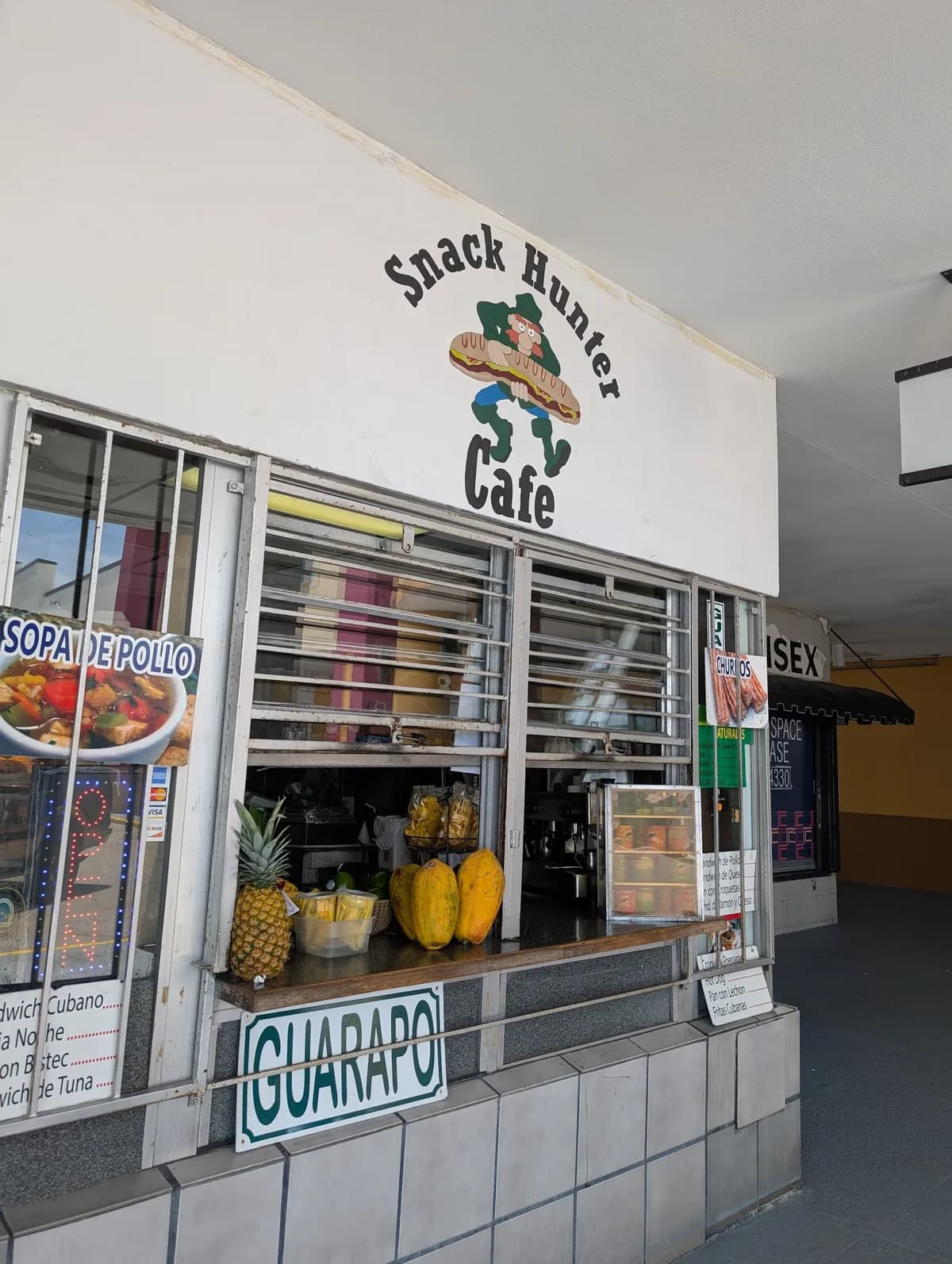 The Snack Hunter storefront with its hand-painted sign